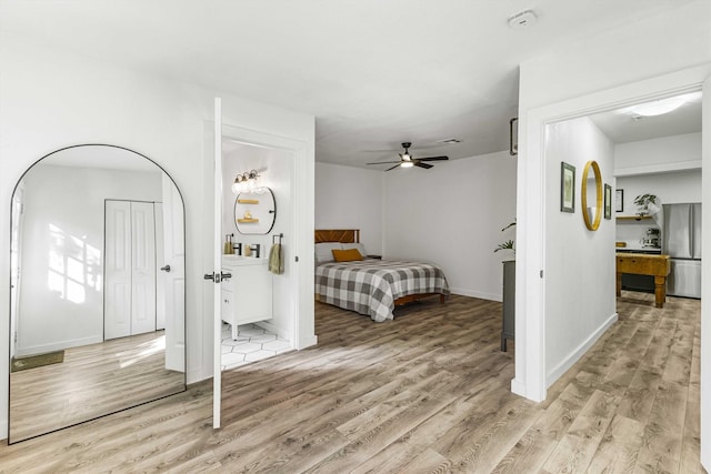 909 N 30th St, Waco, TX 76707 - bedroom with freestanding refrigerator, light wood finished floors, and baseboards