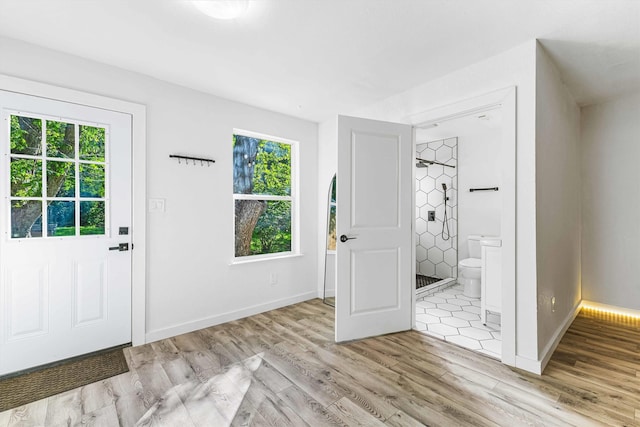 909 N 30th St, Waco, TX 76707 - entryway featuring plenty of natural light, light wood-type flooring, and baseboards
