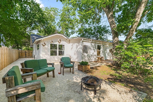 909 N 30th St, Waco, TX 76707 - rear view of property featuring a fenced backyard, an outdoor living space with a fire pit, and a patio area