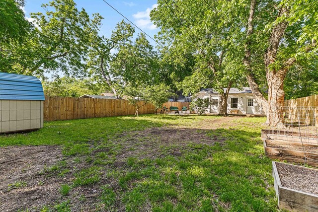 909 N 30th St, Waco, TX 76707 - view of yard with a garden, a shed, and an outdoor structure