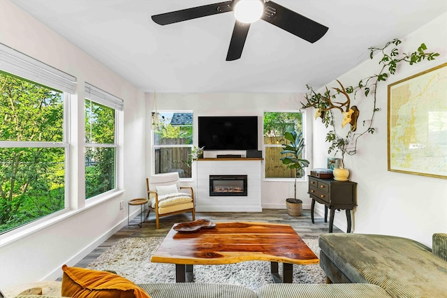 909 N 30th St, Waco, TX 76707 - living area featuring a glass covered fireplace, wood finished floors, ceiling fan, and baseboards