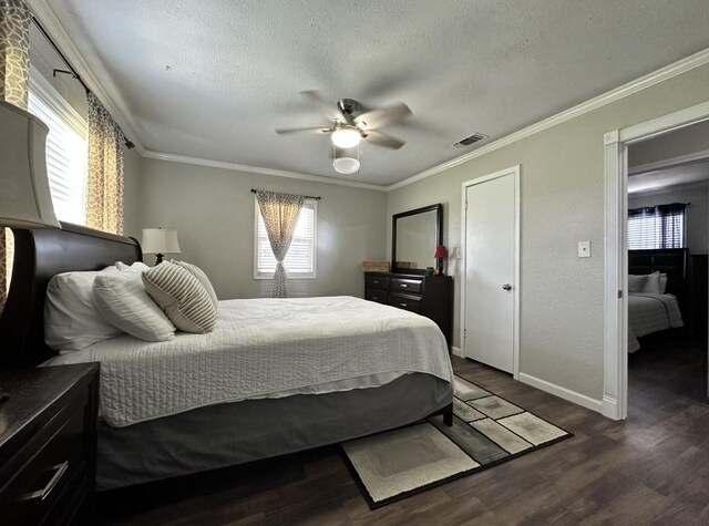 bedroom featuring baseboards, dark wood-style floors, a textured ceiling, crown molding, and ceiling fan