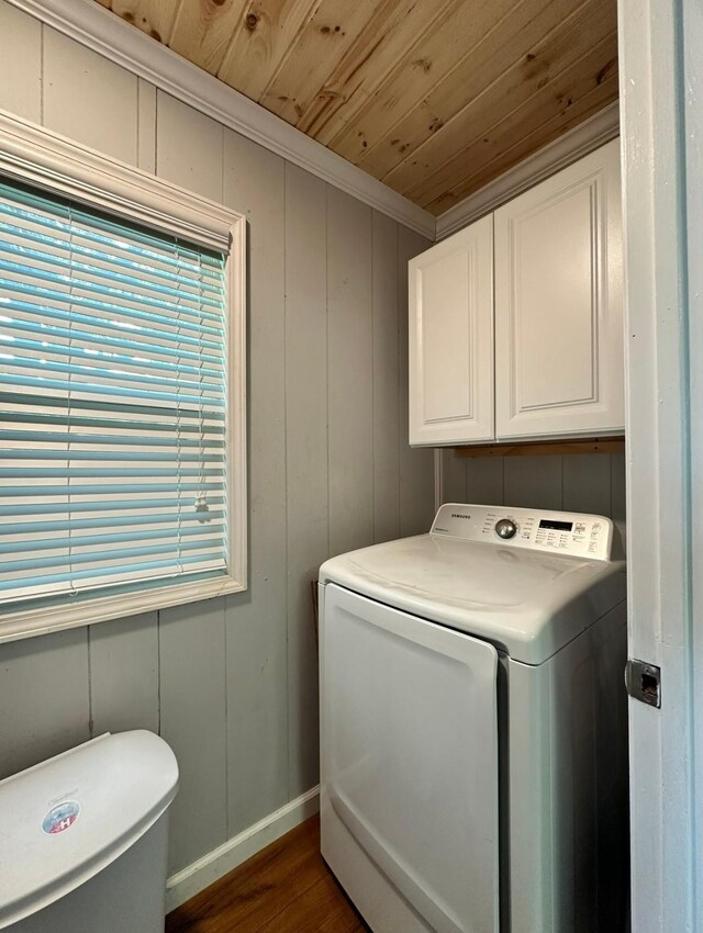 laundry room featuring washer / clothes dryer, wooden ceiling, cabinet space, dark wood-style flooring, and ornamental molding