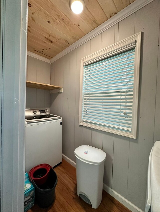 bathroom with washer / clothes dryer, wooden ceiling, wood finished floors, crown molding, and baseboards