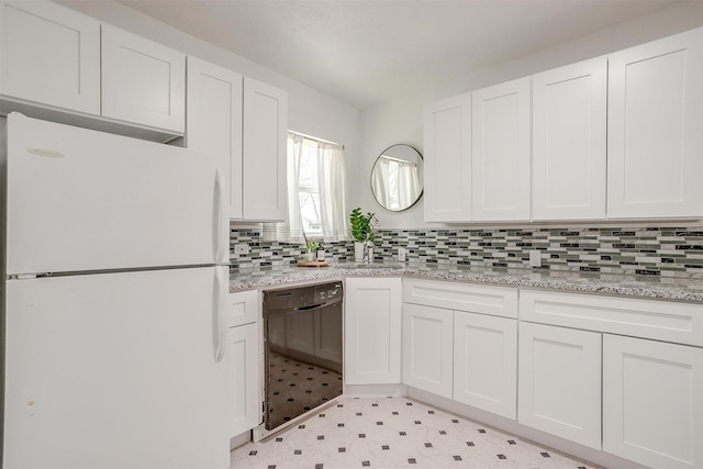 kitchen featuring freestanding refrigerator, dishwasher, white cabinetry, and light flooring