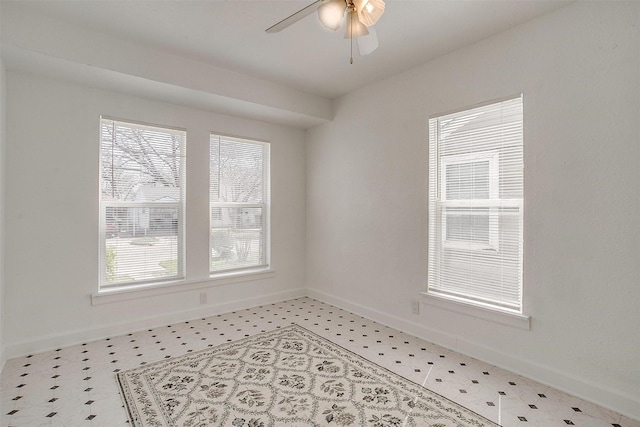 unfurnished room with light flooring, baseboards, and ceiling fan