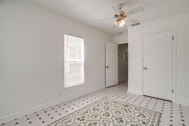 spare room with light flooring, baseboards, and ceiling fan