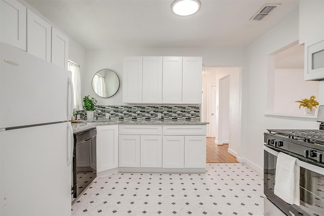 kitchen featuring white appliances, white cabinets, backsplash, light stone countertops, and light floors