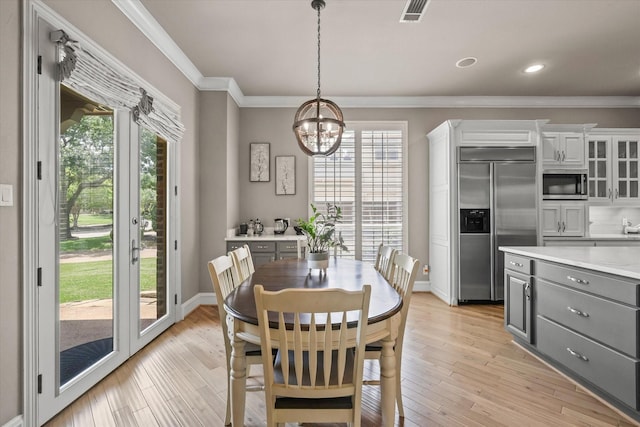 7208 Majestic Mnr, Colleyville, TX 76034 - dining space featuring crown molding, healthy amount of natural light, a chandelier, light wood finished floors, and baseboards