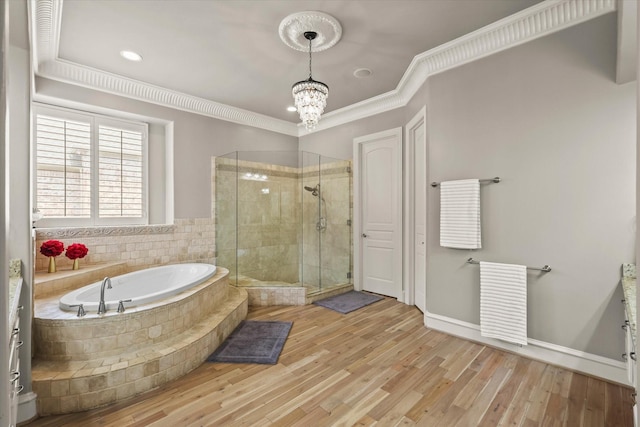 7208 Majestic Mnr, Colleyville, TX 76034 - bathroom featuring a bath, a stall shower, a chandelier, ornamental molding, and wood finished floors