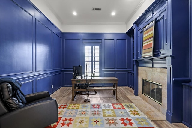 7208 Majestic Mnr, Colleyville, TX 76034 - office area featuring a decorative wall, light wood finished floors, a fireplace, and crown molding