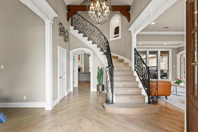 7208 Majestic Mnr, Colleyville, TX 76034 - entrance foyer featuring stairs, arched walkways, baseboards, decorative columns, and a chandelier