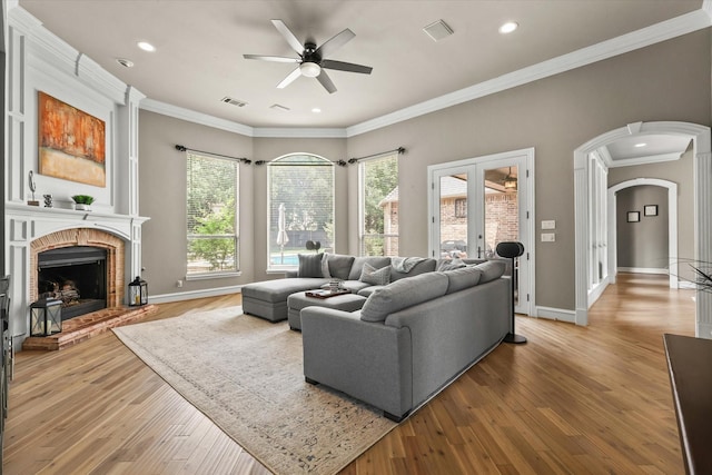 7208 Majestic Mnr, Colleyville, TX 76034 - living room featuring a ceiling fan, baseboards, arched walkways, crown molding, and hardwood / wood-style floors