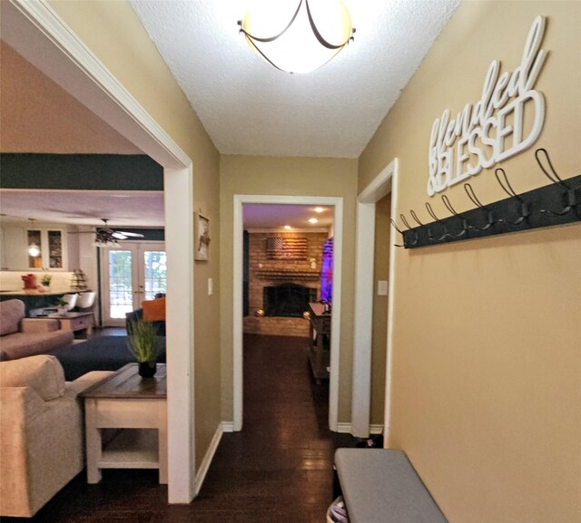 hallway with dark wood-style flooring, baseboards, and french doors