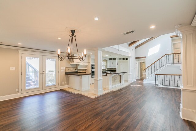 unfurnished dining area with dark wood finished floors, a chandelier, recessed lighting, and baseboards