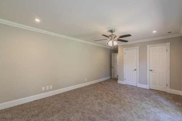unfurnished bedroom with two closets, carpet, recessed lighting, baseboards, and crown molding