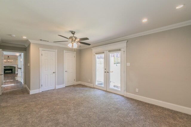 unfurnished bedroom with french doors, access to exterior, carpet floors, crown molding, and baseboards