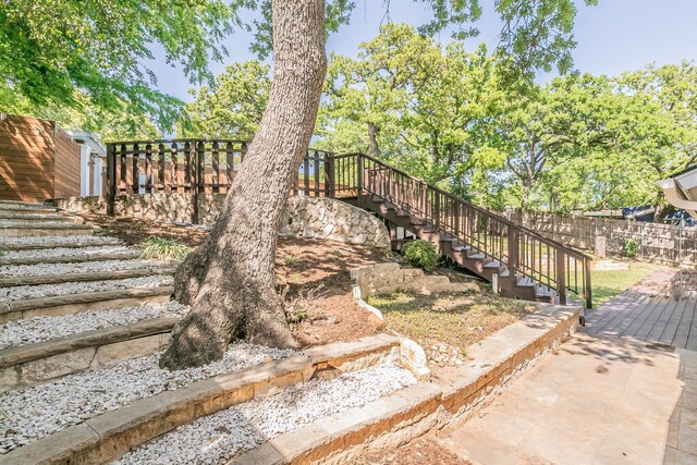 view of yard with stairway, fence, and a patio