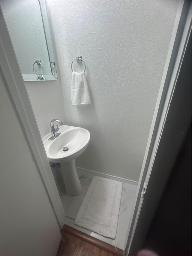 1220 Westmoreland Dr, Mckinney, TX 75069 - bathroom with marble finish flooring, baseboards, and a sink