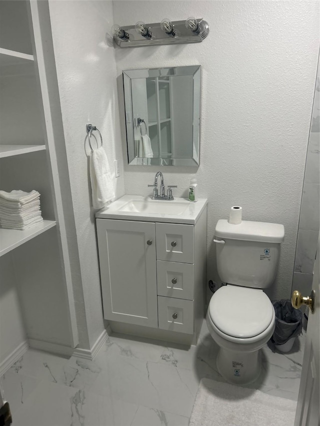 1220 Westmoreland Dr, Mckinney, TX 75069 - bathroom with marble finish floors, vanity, toilet, and baseboards