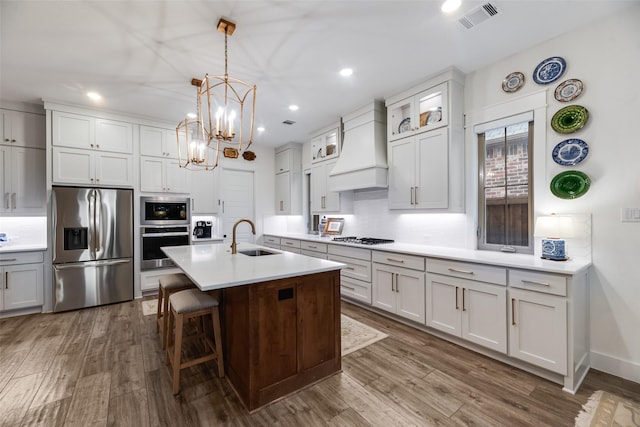 2218 Somercrest Pl, Midlothian, TX 76065 - kitchen with stainless steel appliances, custom exhaust hood, a sink, dark wood-style floors, and a chandelier