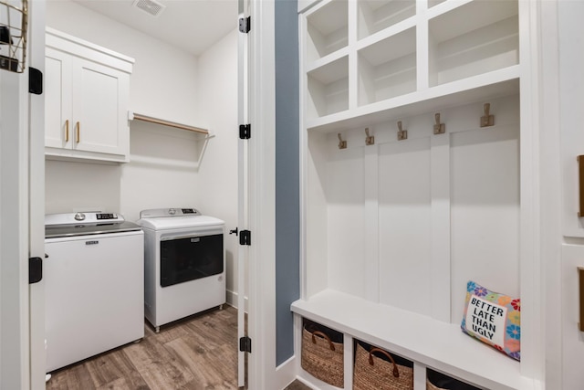 2218 Somercrest Pl, Midlothian, TX 76065 - laundry room with washing machine and clothes dryer, light wood-style floors, and cabinet space