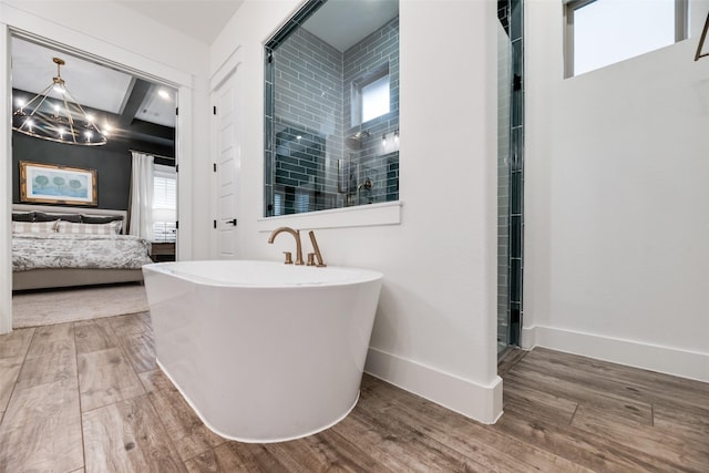 2218 Somercrest Pl, Midlothian, TX 76065 - ensuite bathroom featuring a chandelier, wood finished floors, tiled shower, a freestanding tub, and baseboards