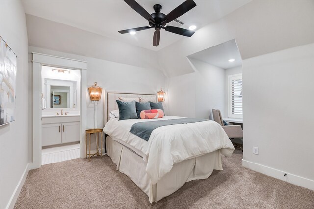 bedroom with light carpet, a sink, baseboards, and connected bathroom