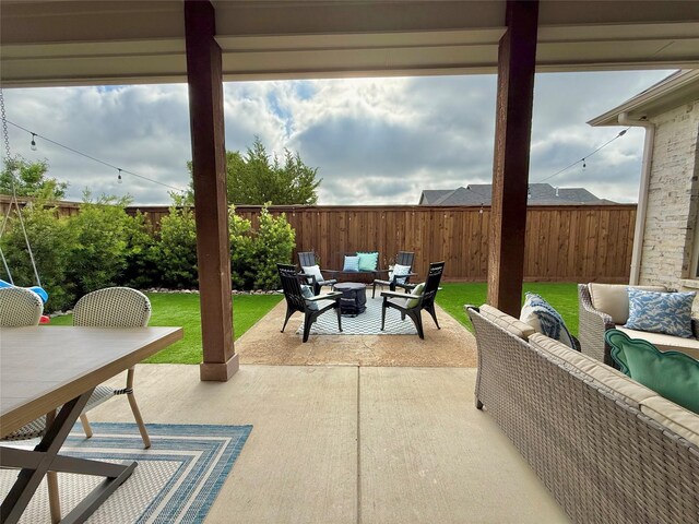view of patio / terrace with an outdoor living space with a fire pit and outdoor dining space