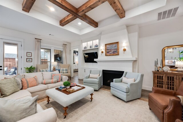 living area with light wood-style flooring, coffered ceiling, beamed ceiling, recessed lighting, and a fireplace