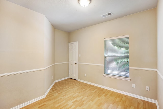 empty room with wood finished floors and baseboards