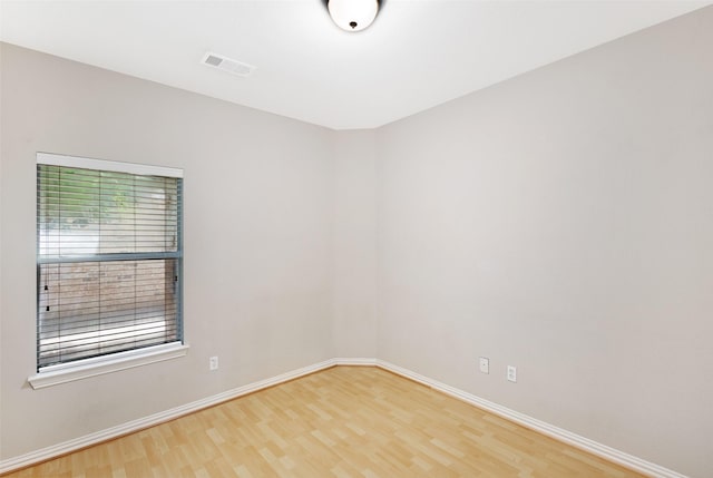 empty room with wood finished floors and baseboards
