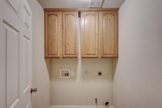 washroom featuring hookup for a gas dryer, hookup for an electric dryer, hookup for a washing machine, and cabinet space