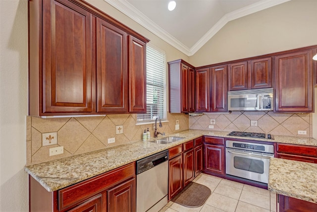 kitchen with appliances with stainless steel finishes, dark brown cabinets, a sink, ornamental molding, and light stone counters