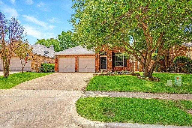 view of front of home featuring a garage, driveway, brick siding, and a front yard