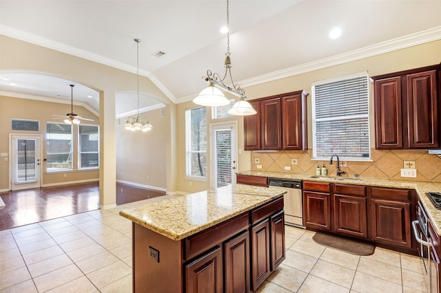 kitchen featuring dishwasher, a sink, light tile patterned flooring, vaulted ceiling, and healthy amount of natural light