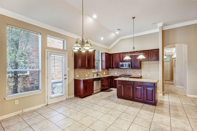 kitchen with stainless steel appliances, decorative backsplash, arched walkways, light tile patterned floors, and vaulted ceiling
