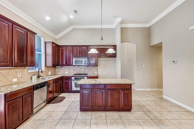 kitchen with stainless steel appliances, a sink, reddish brown cabinets, backsplash, and light stone counters