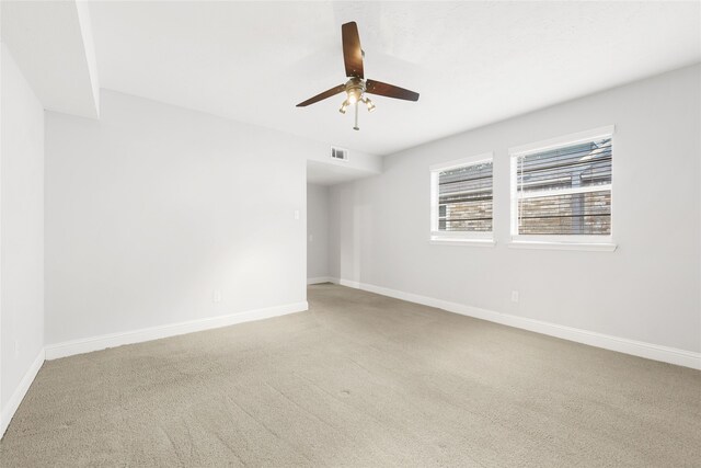 spare room with ceiling fan, carpet floors, and baseboards