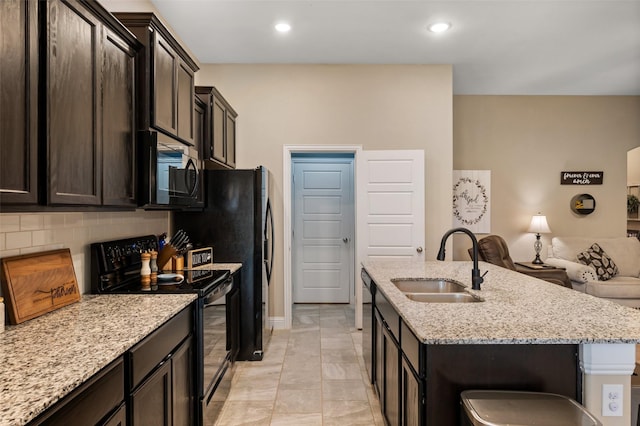 1461 Lakeview Dr, Pelican Bay, TX 76020 - kitchen featuring black electric range, a sink, open floor plan, a kitchen island with sink, and decorative backsplash