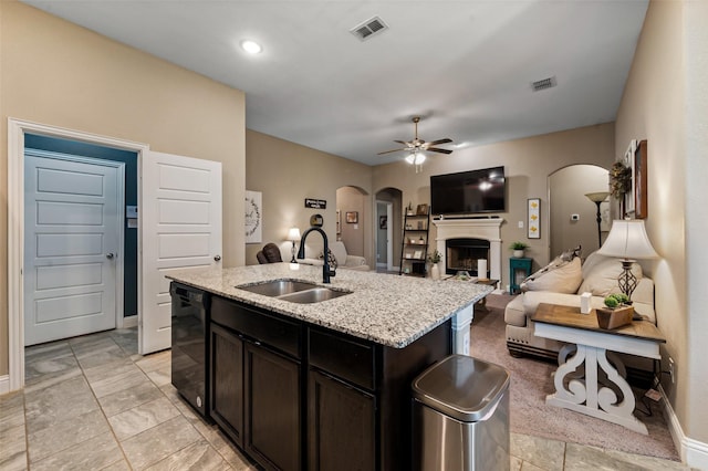 1461 Lakeview Dr, Pelican Bay, TX 76020 - kitchen featuring arched walkways, a sink, black dishwasher, ceiling fan, and light stone countertops