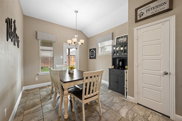 1461 Lakeview Dr, Pelican Bay, TX 76020 - dining area featuring baseboards, stone tile flooring, a chandelier, and lofted ceiling