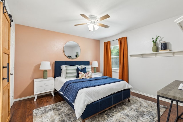 7116 Independence Dr, The Colony, TX 75056 - bedroom with a barn door, wood finished floors, baseboards, and a ceiling fan