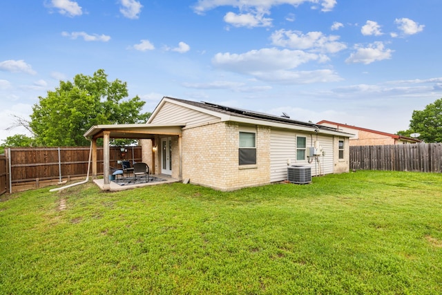 7116 Independence Dr, The Colony, TX 75056 - back of house with brick siding, central AC, a patio, and solar panels