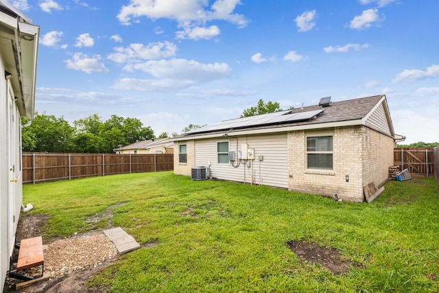 7116 Independence Dr, The Colony, TX 75056 - rear view of property with central air condition unit, roof mounted solar panels, and brick siding