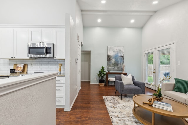 7116 Independence Dr, The Colony, TX 75056 - living area with high vaulted ceiling, dark wood finished floors, french doors, recessed lighting, and baseboards