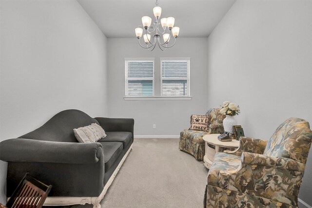 sitting room featuring a chandelier, carpet flooring, and baseboards