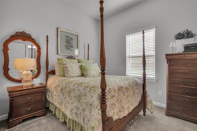 bedroom featuring light colored carpet, multiple windows, and baseboards