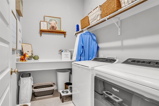 laundry area featuring washer and clothes dryer and tile patterned flooring