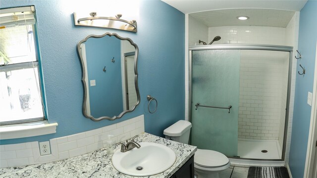 2308 16th St, Brownwood, TX 76801 - bedroom with wood finished floors, multiple windows, and baseboards